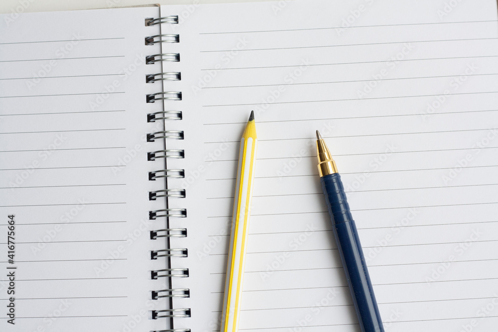 Writing and planning, notebook, pencil and pen, top view Writing and planning, notebook, pencil and pen, top view