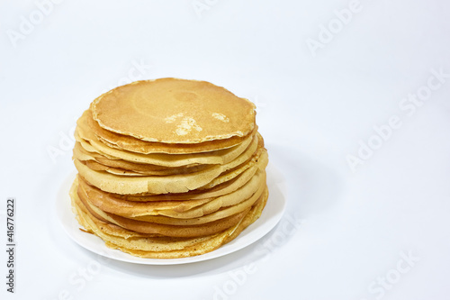 a stack of Russian pancakes on a white background, pancakes on Shrovetide before Lent