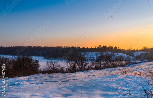 Footsteps along the railway tracks in winter at sunset