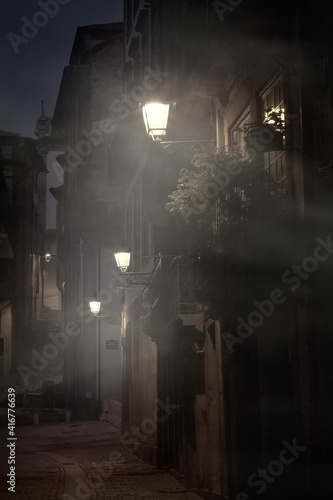 Old alley in a foggy night