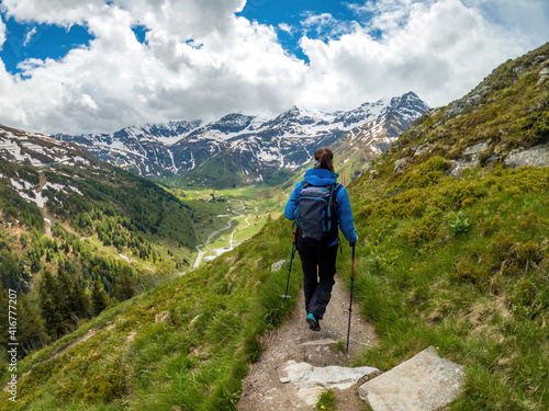 A young female hiker does trail hiking in the mountains of Gastein in Austria.