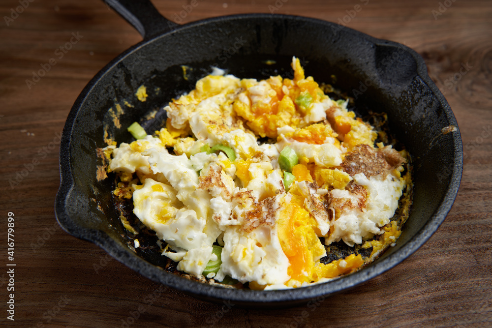 Scrambled eggs on a wooden board Scrambled eggs on a wooden board