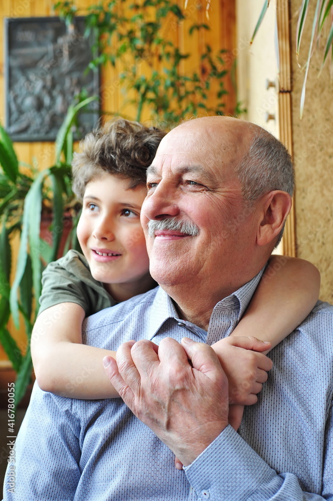 Fototapeta premium Grandfather and grandson are having fun, enjoying communication with each other.