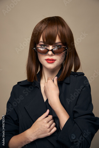 Fashionable woman Model portrait black coat makeup dark glasses