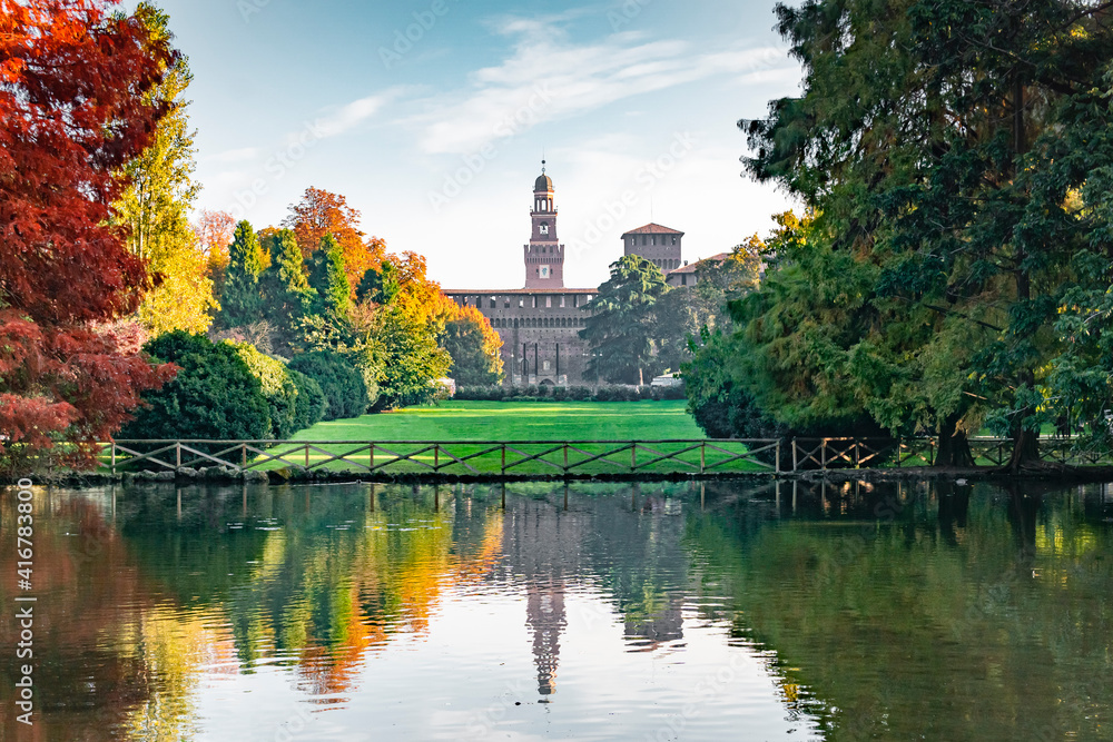 View of the Sforza Castle from Sempione Park (Milan - Italy) in an autumn day with a small lake in the foreground. View of the Sforza Castle from Sempione Park (Milan - Italy) in an autumn day with a small lake in the foreground.