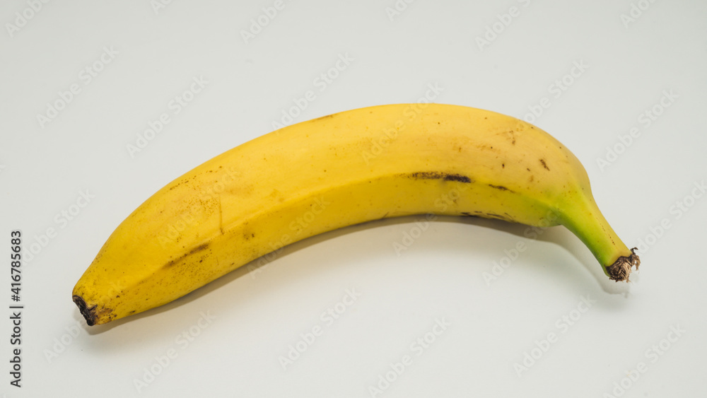 Close-up of yellow banana on white background.