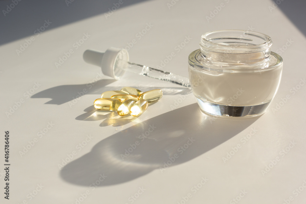 Skin care and supplements for clear and radiant skin. Closeup of beauty products and vitamin D capsules.