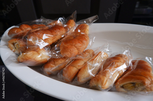 Fresh bread wrapped in hygienic plastic photo