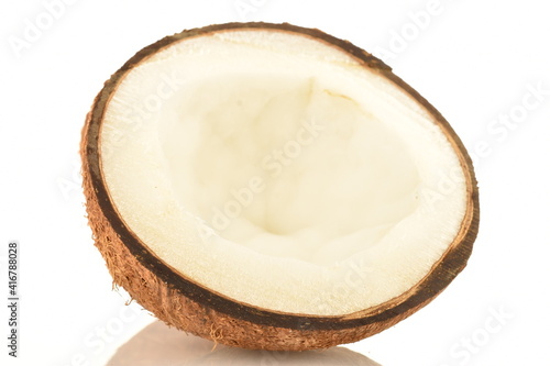 One half of a ripe organic coconut, close-up, isolated on white.