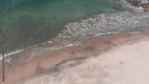 Aerial views of waves crashing at Penca beach in Guanacaste, Costa Rica