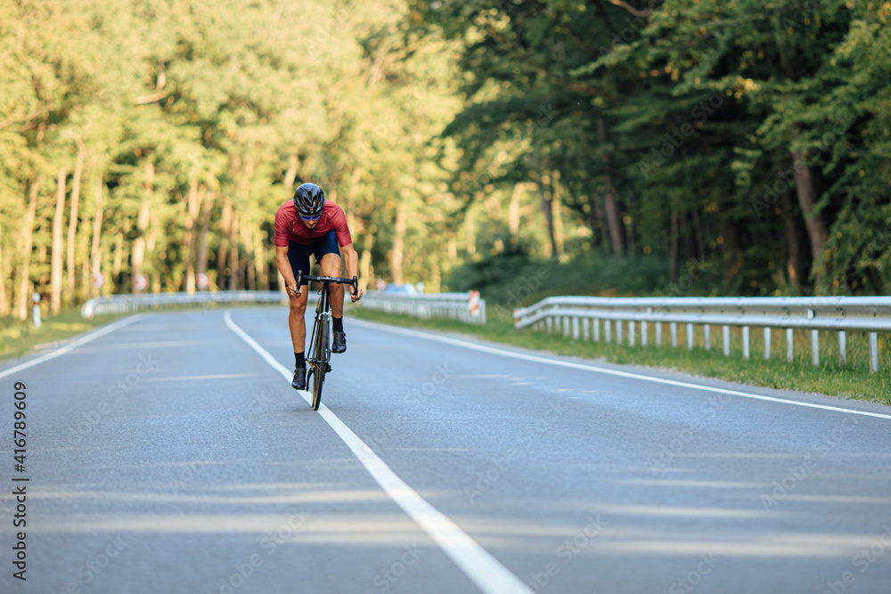 Man riding bike with high speed on asphalt road Man riding bike with high speed on asphalt road