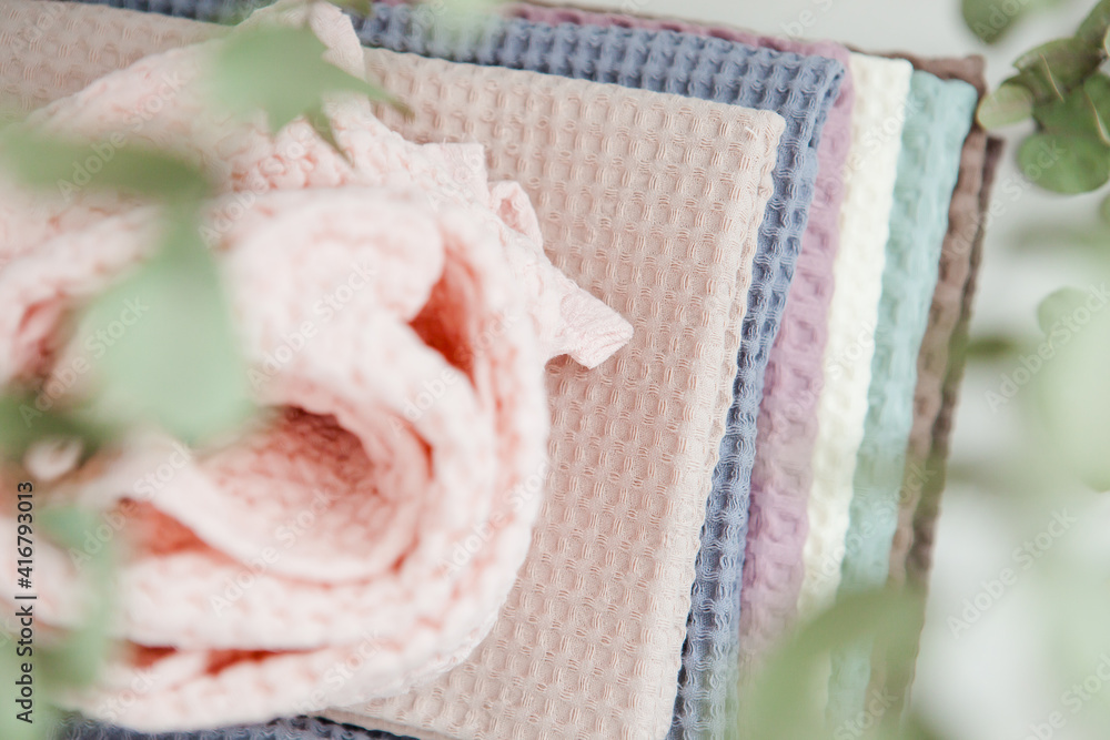photo in light pastel colors, a stack of towels on a light background photo in light pastel colors, a stack of towels on a light background