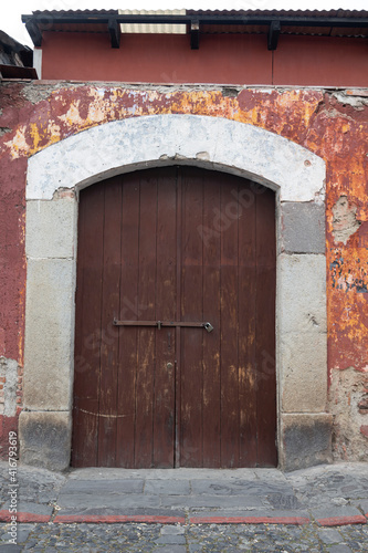 wooden door in colonial type house stone frame close up in old street (ID: 416793619)