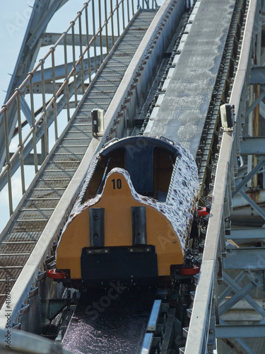 Empty log carriage number 10 on the Log Flume ride Pleasure Beach Great Yarmouth. An empty carriage number 10, up rubber belt section to the highest point on the log flume ride in Great Yarmouth. photo