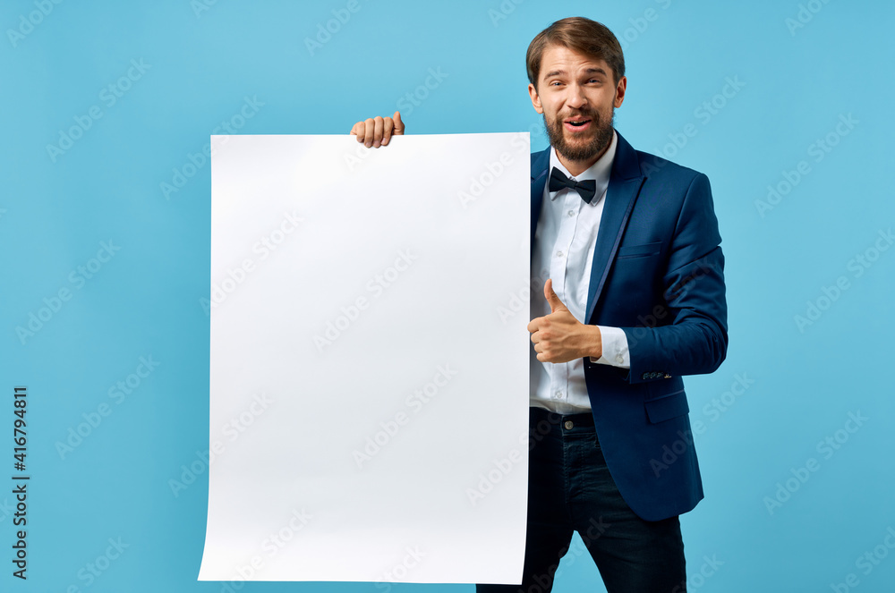a man in a suit holding a banner in front of him advertising presentation official a man in a suit holding a banner in front of him advertising presentation official