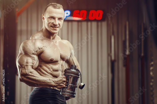 Bodybuilder with protein powder supplements jar © antondotsenko