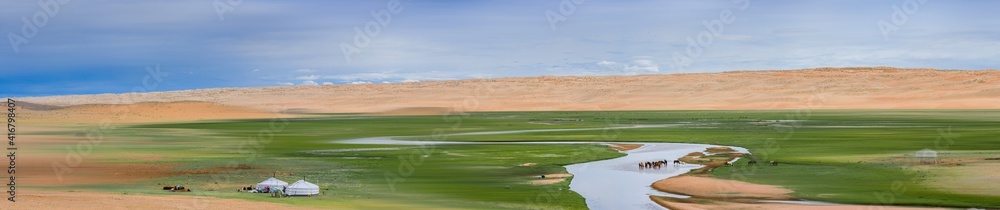 Naklejka premium landscape of amazing lake with horses on shore at sunn day