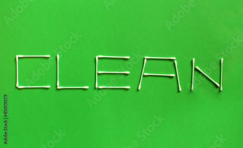 Clean is the word made up with cotton swabs on green background