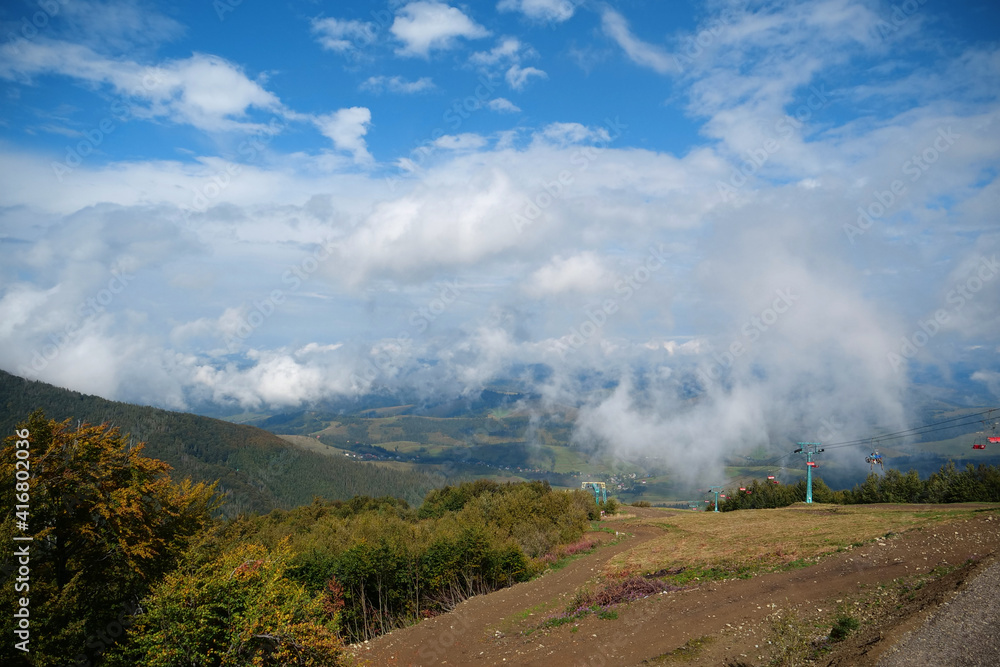 Panorama view of clouds and chair lift in Carpathian Mountains Panorama view of clouds and chair lift in Carpathian Mountains