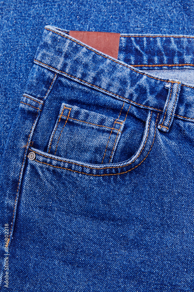 Closeup of cotton blue jeans with tiny pocket, normal pocket and lining, with space to text Closeup of cotton blue jeans with tiny pocket, normal pocket and lining, with space to text