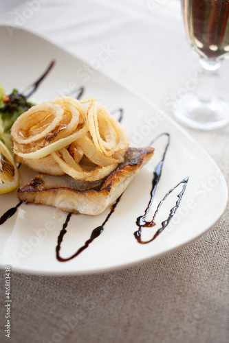 Fish under the onion pillow and salad