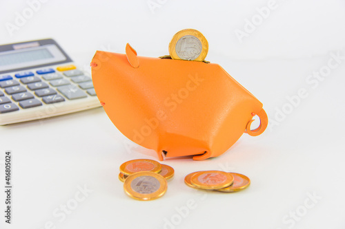 Brazilian real coin on top of a piggy bank, saving money, savings photo