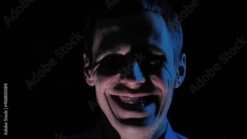 Man in the dark with creepy smile