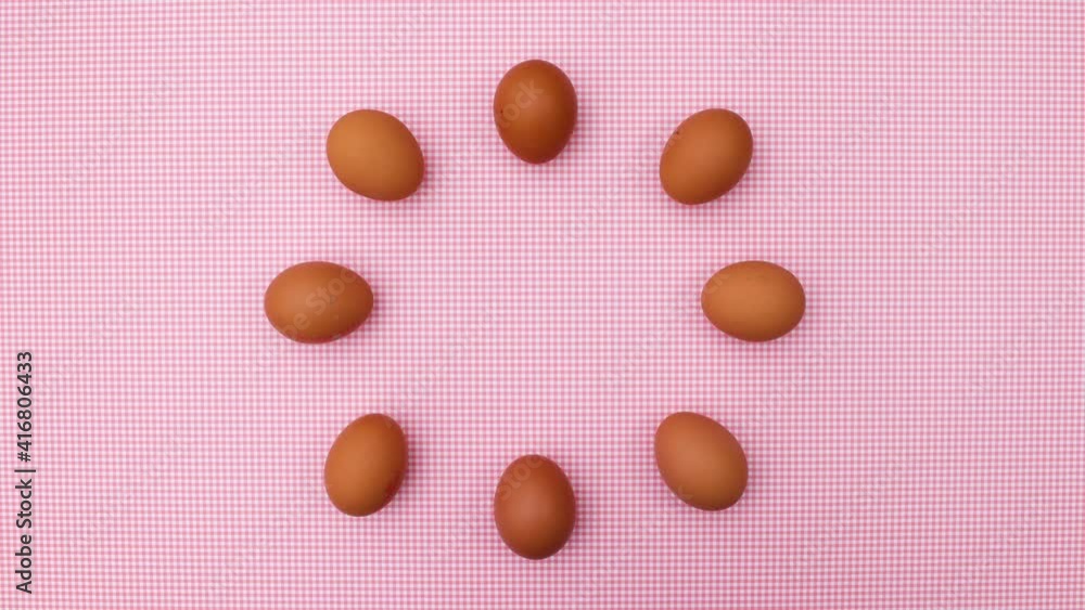 Fresh eggs appear in circle on pink theme. Stop motion Fresh eggs appear in circle on pink theme. Stop motion