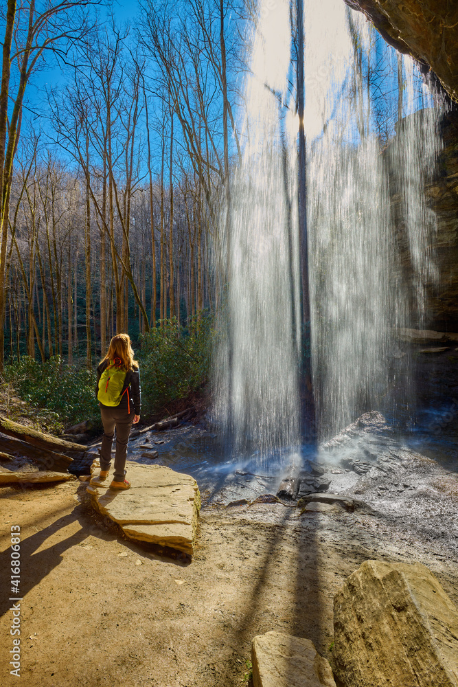 Woman standing near Moore Cove Waterfall in Pisgah National Forest near Brevard NC. Woman standing near Moore Cove Waterfall in Pisgah National Forest near Brevard NC.