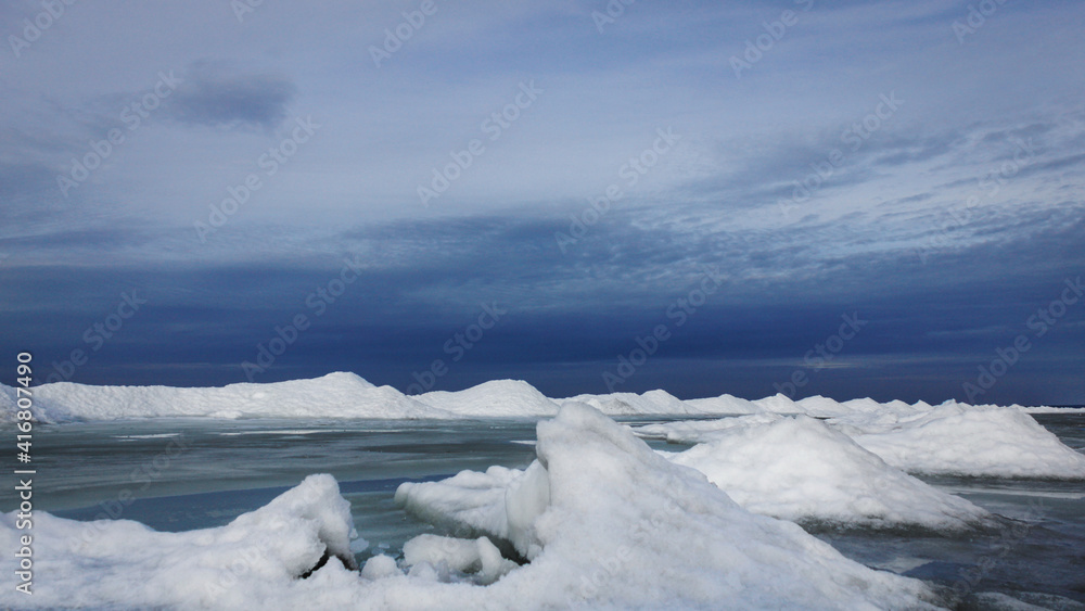 Beach glaciers on a sunny winter day. Everything is frozen, the sky is very blue. Beach glaciers on a sunny winter day. Everything is frozen, the sky is very blue.