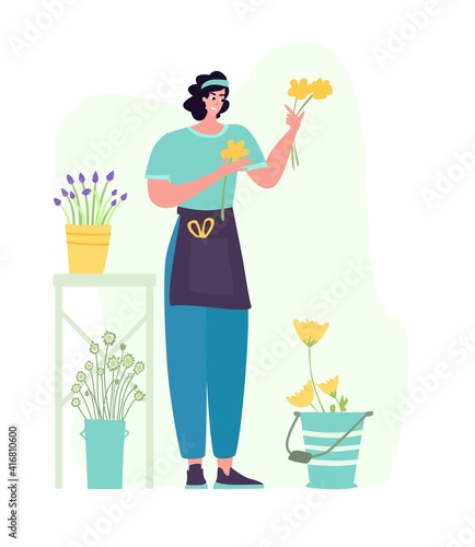 Woman compose bouquet on table. Forist shop or store.
