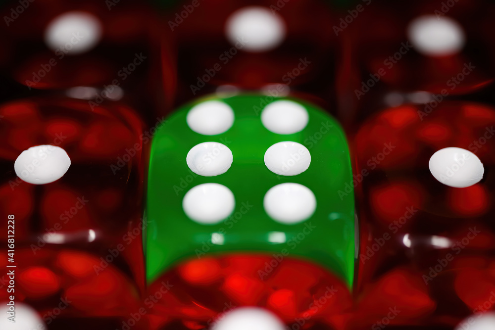 Makro closeup of green dice with face number six between red dices one (focus on points in center) Makro closeup of green dice with face number six between red dices one (focus on points in center)