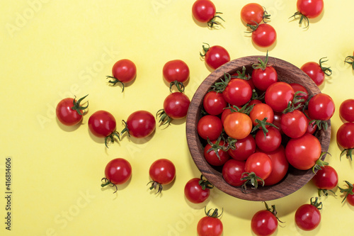 Cherry tomatoes on a yellow background. Food Background Tomatoes