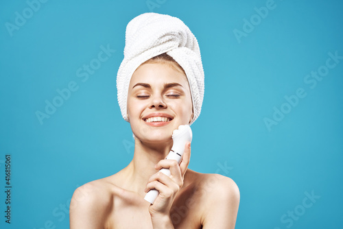 pretty woman naked shoulders towel on head massage blue background