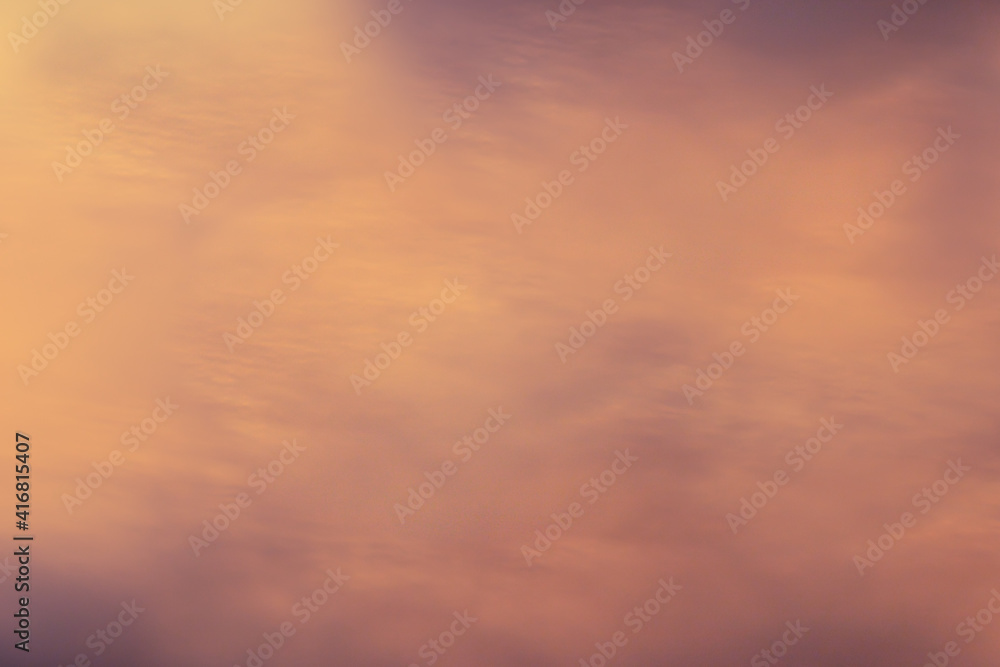 Abstract blurred background of yellow, gold and orange colors, imitation of a blurry sunset
