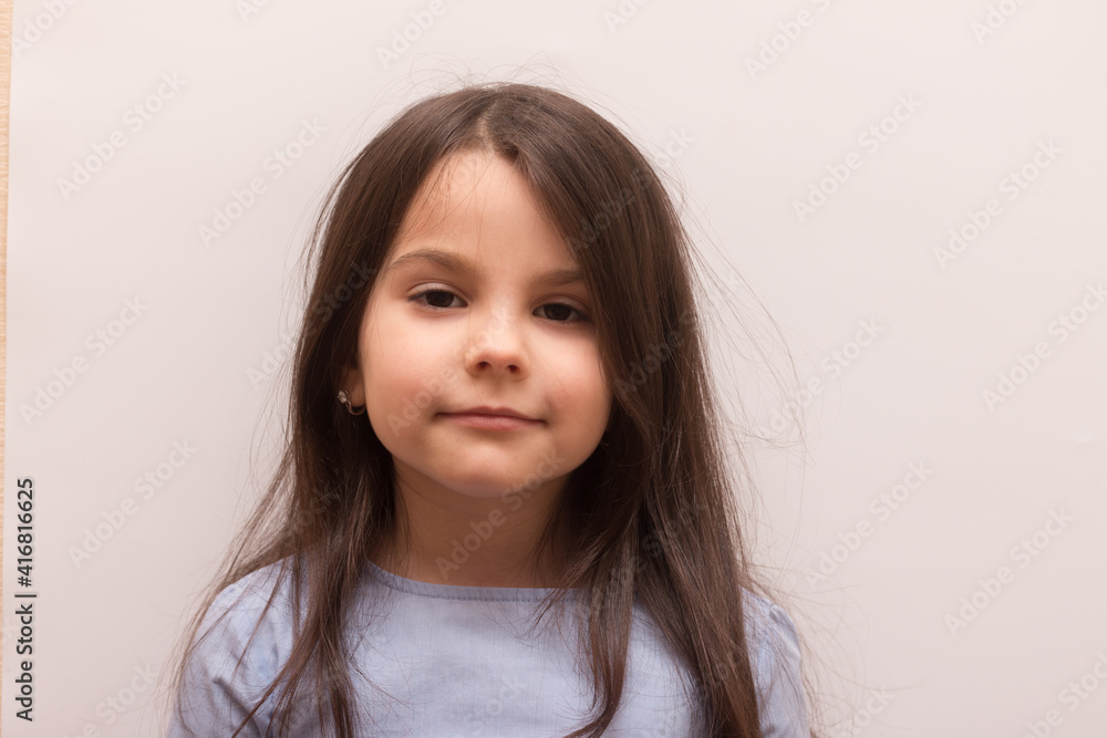 Smiling sad mysterious white little girl with closed eyes on white background Smiling sad mysterious white little girl with closed eyes on white background