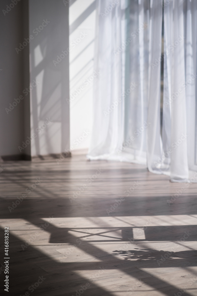 beautiful room with white walls and light parquet in the morning sun beautiful room with white walls and light parquet in the morning sun
