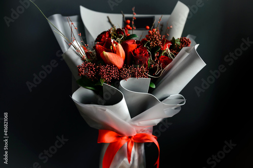 Bouquet of red roses in gray foamiran paper on a black background