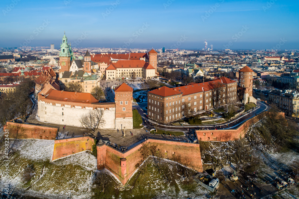 Royal Wawel Cathedral and castle in Krakow, Poland. Aerial view in sunset light in winter with a promenade and walking people