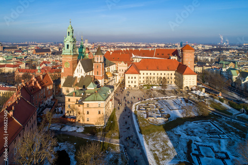 Royal Wawel Cathedral and castle in Krakow, Poland. Aerial view in sunset light in winter with a park and walking people on the courtyard