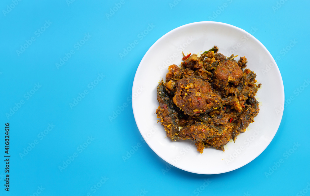 Stir fried catfish with curry paste on blue background. Stir fried catfish with curry paste on blue background.