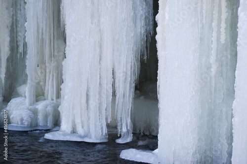 Ice hangs down in front of a walkway
