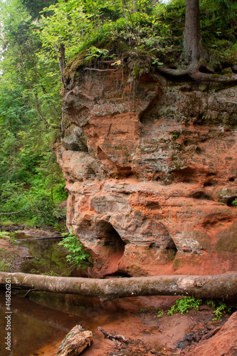 The cave entrance is a red sandstone. Detail of red sandstone mountains