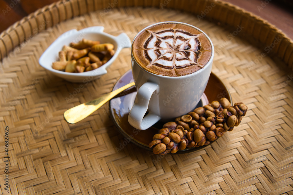 Fresh coffee in civet glass placed on a rattan tray Fresh coffee in civet glass placed on a rattan tray