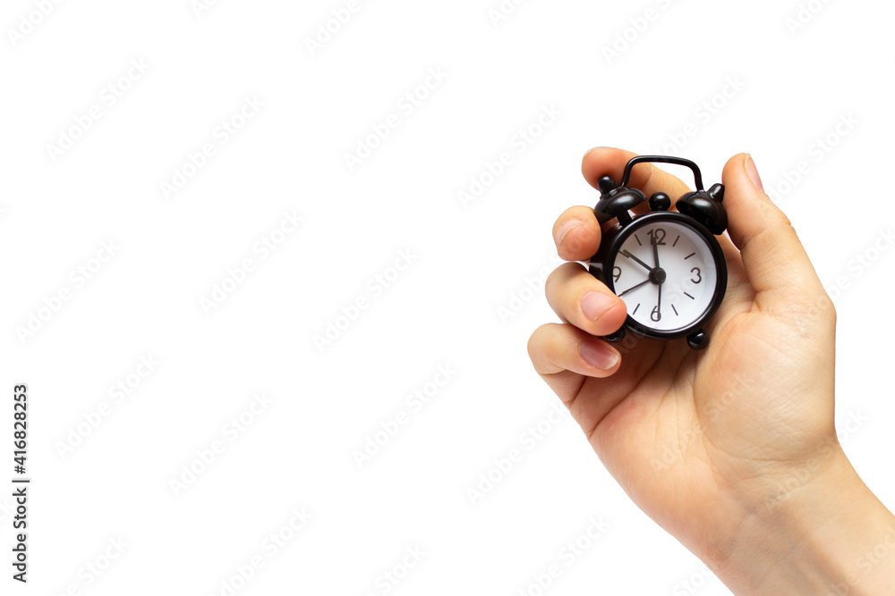 Creative idea about time. Black alarm clock in a female hand. Creative idea about time. Black alarm clock in a female hand.