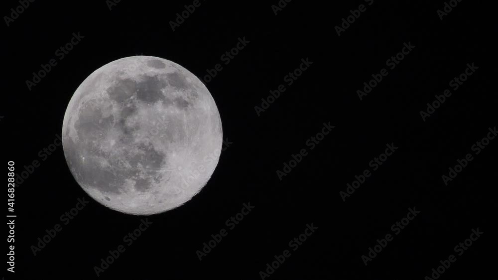 The full moon moves quickly in the dark sky. Werewolf red full moon. Dramatic sky view, time lapse The full moon moves quickly in the dark sky. Werewolf red full moon. Dramatic sky view, time lapse