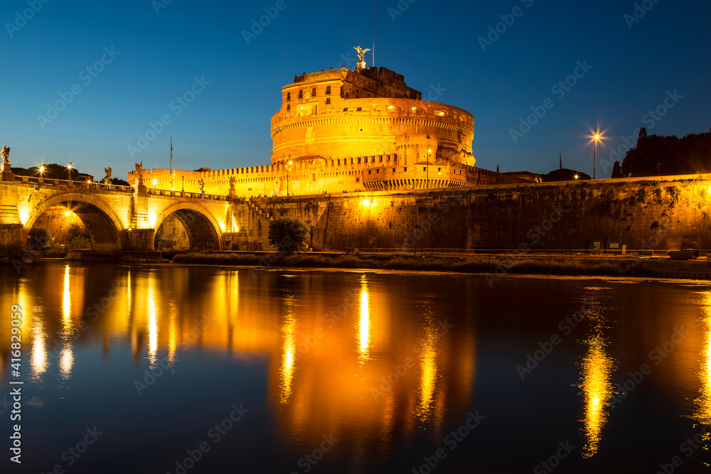 View of the Castle of St. Angelo or the Mausoleum of Hadrian and the bridge of St. Angelo at night, Italy