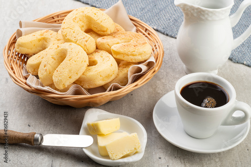 Chipas, typical south american cheese bun in a basket with butter and coffee photo