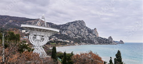 panoramic landscape with large astronomical radio telescope on the seashore photo