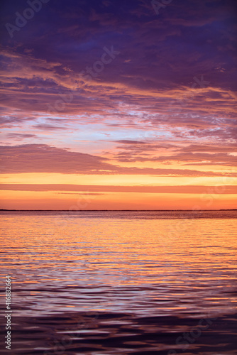Sunrise sun over skyline horizon. Natural sunset over ocean. Dramatic sky. © Volodymyr